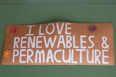 Photo of a sign that says 'I love renewables and permaculture'