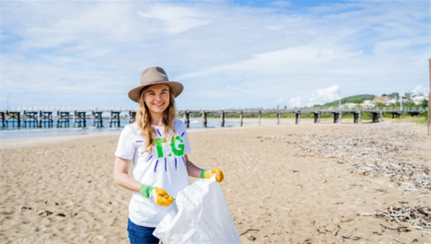 Photo of a woman picking up rubbish.png