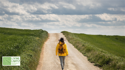 Photo of a woman walking down a long road.png